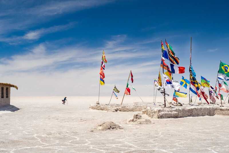 Colorful flags from all over the world at Uyuni salt flats in Bolivia, South America By wirestock