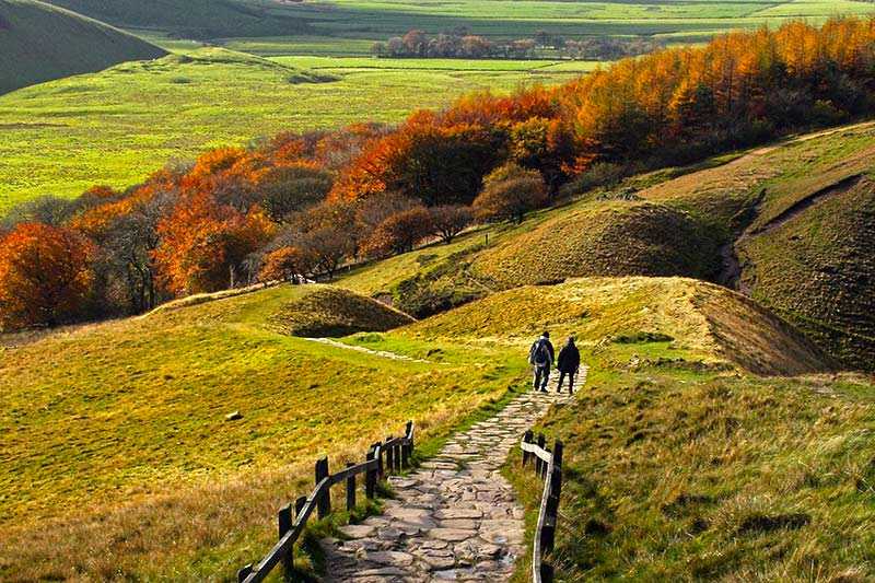 mam-tor-two-walkers-walking-across-the-ridge-at-mam-tor-castleton-derbyshire