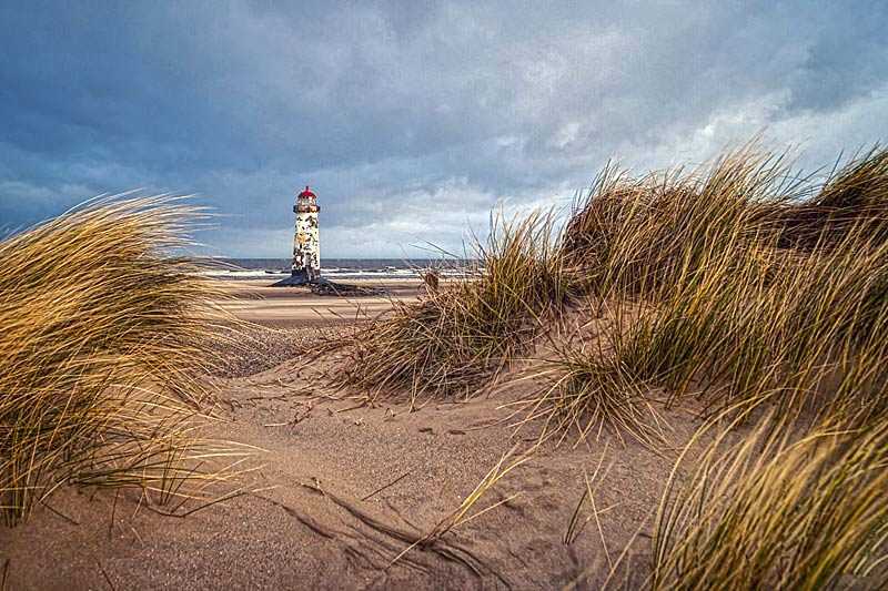 point-of-ayr-talacre-beach-photograph-of-a-lighthouse-on-a-stormy-day-framed-between-sand-dunes