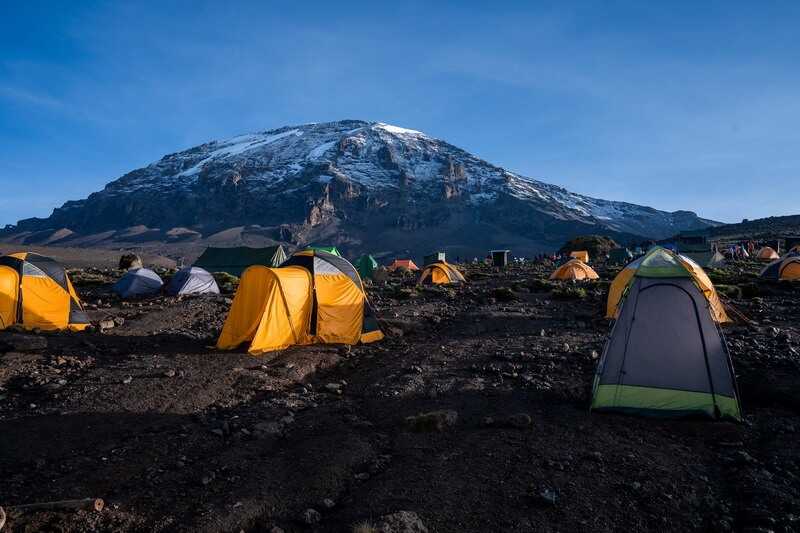 Tents in a camping site near Kilimanjaro mountain in Tanzania by wirestock