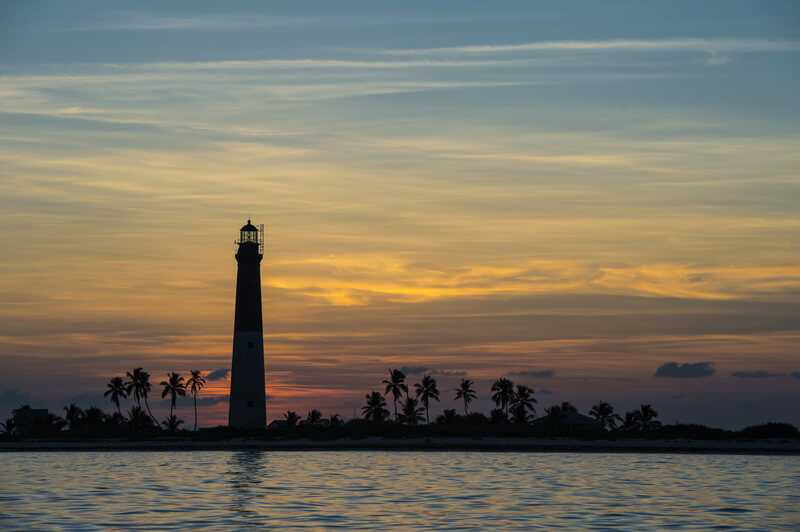 Distance View Of A Dry Tortugas Lighthouse At Scenic Sunset by  ToastedPictures