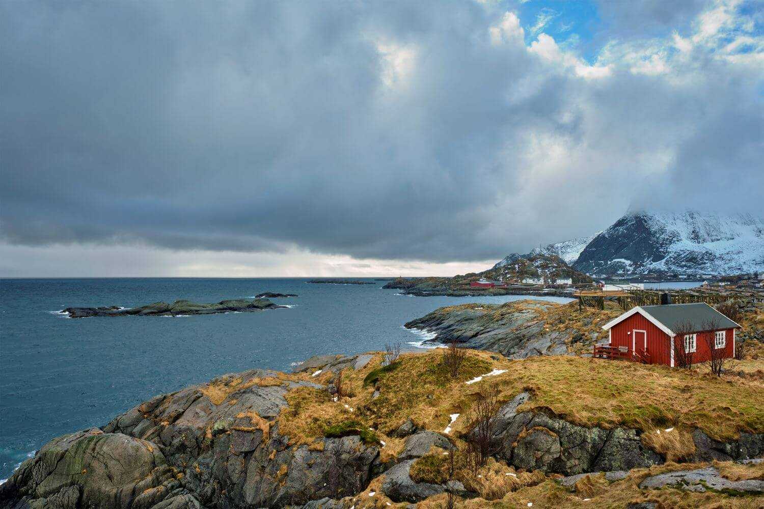 clif-with-traditional-red-rorbu-house-on-lofoten-i-2023-11-27-05-15-48-utc